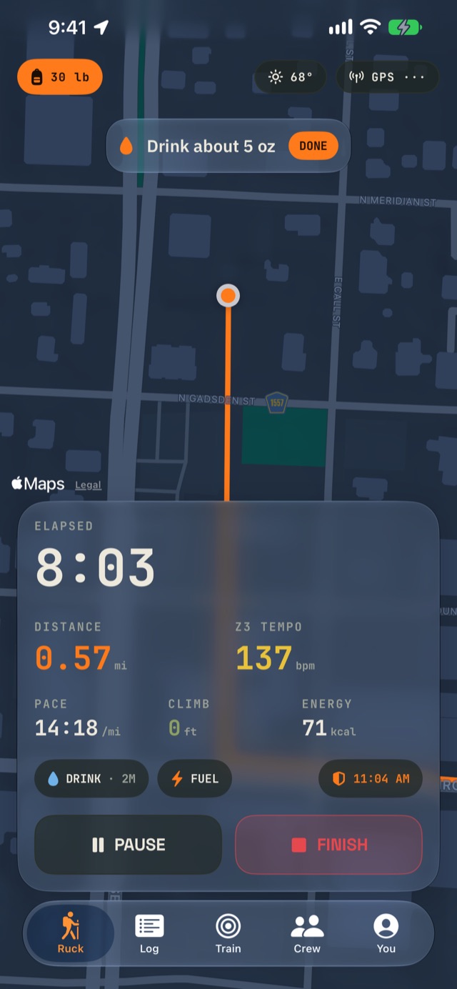 FueledRuck mid-ruck: a heading-up map with a Drink about 5 oz cue, 8:03 elapsed, 0.57 miles, heart rate 137 in zone 3, and a safety check-in chip
